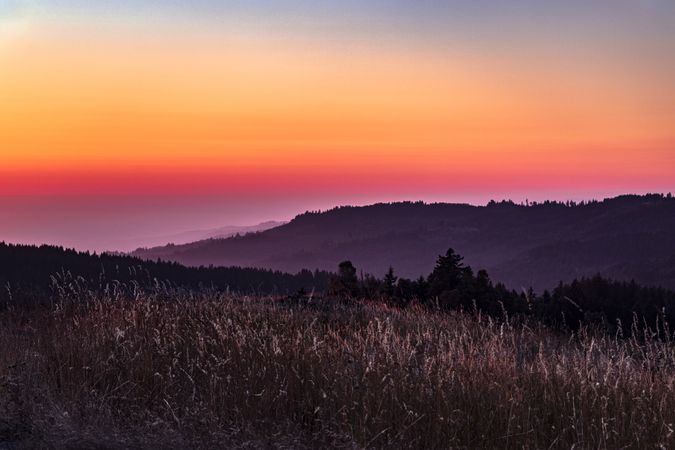 Colorful sunset over coastal hills