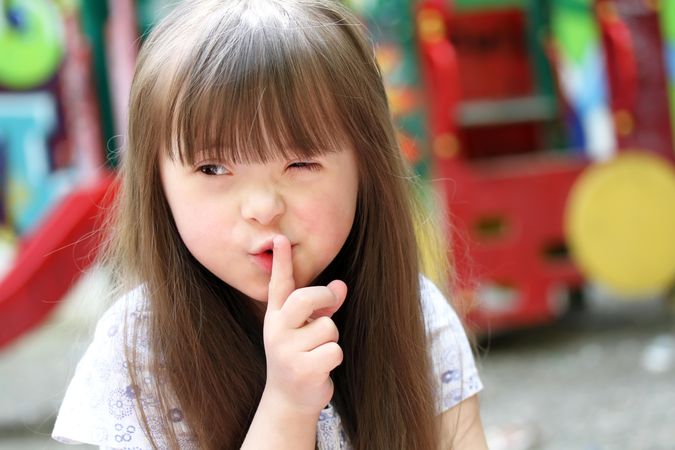 Young girl with Down syndrome with an inquisitive expression