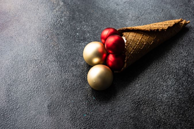 Christmas concept of cone with red and gold baubles