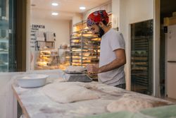 Arabic baker weighting dough with scale