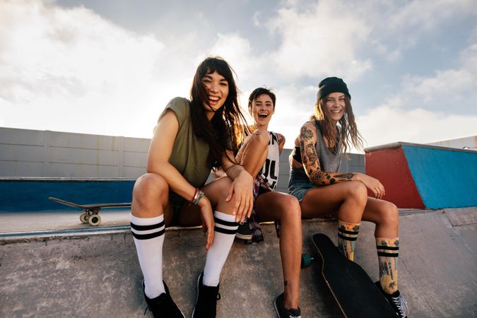 Portrait of three female friends at skate park
