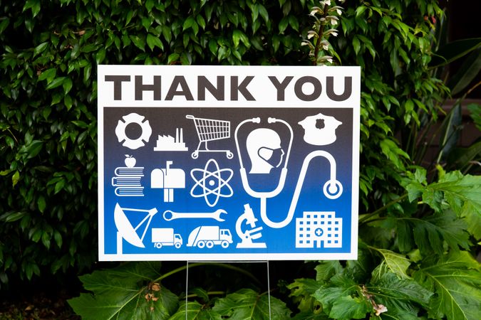 Close up of thank you yard sign for essential workers with icons during lockdown