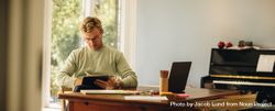 Young man concentrating while using digital tablet 5rxK2b