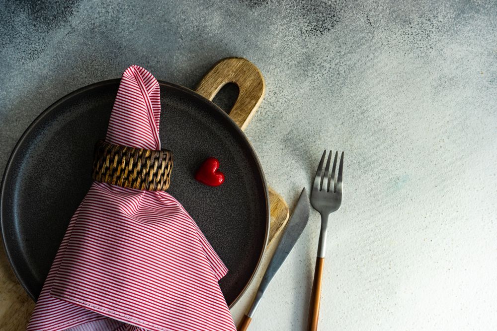 St Valentine day table setting with red napkin, heart and copy space