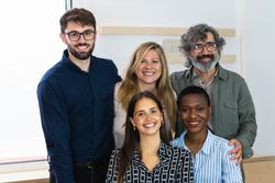Cheerful diverse coworking women looking at camera