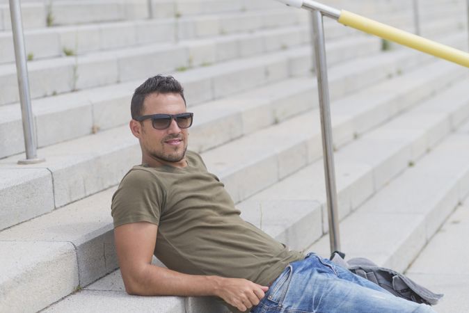 Man reclining on outdoor stairs