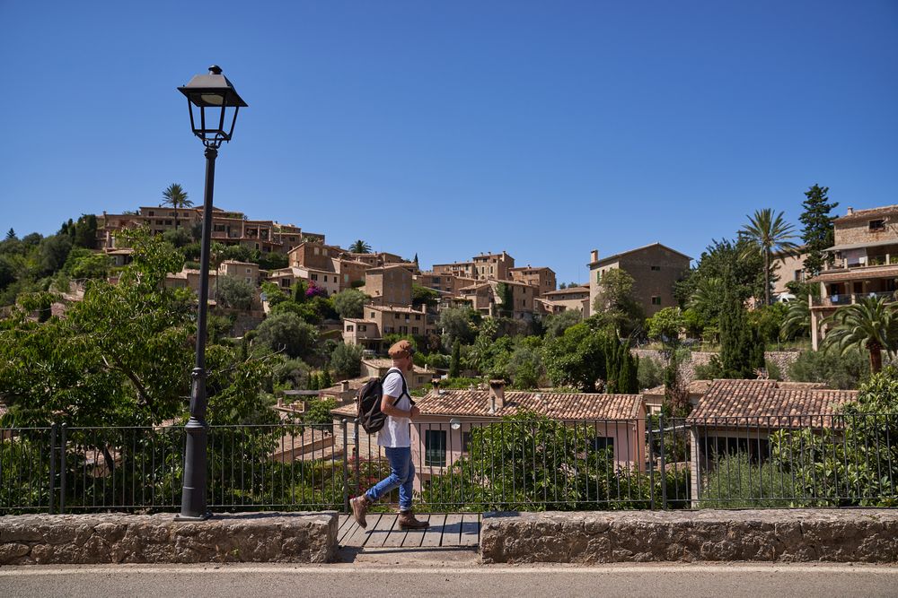 Unrecognizable man walking on pathway in old city