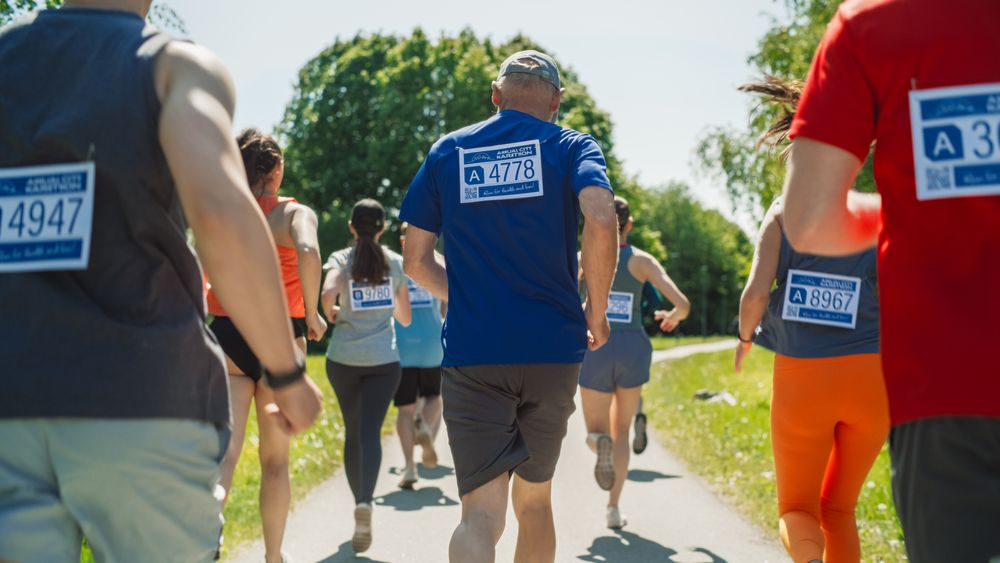 Back View: Portrait of a Diverse Group of People Participating in a Marathon and Running Through a Park Trail.