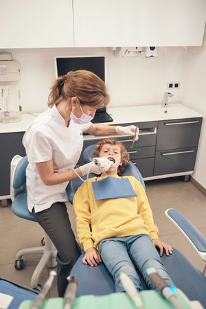 Female dentist applying intraoral scanner for getting dental casts