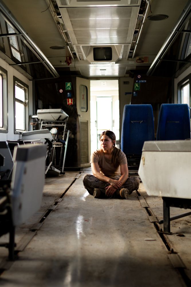 Female soldier on floor of military vehicle