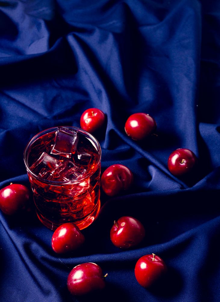 Red drink near fresh fruits