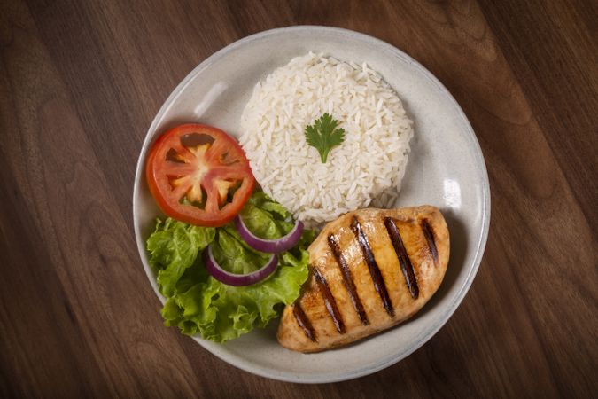 Grilled chicken with salad and rice.