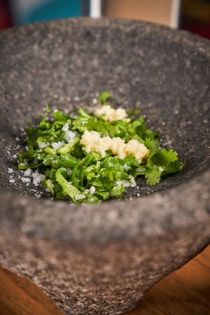 Greens with garlic in mortar