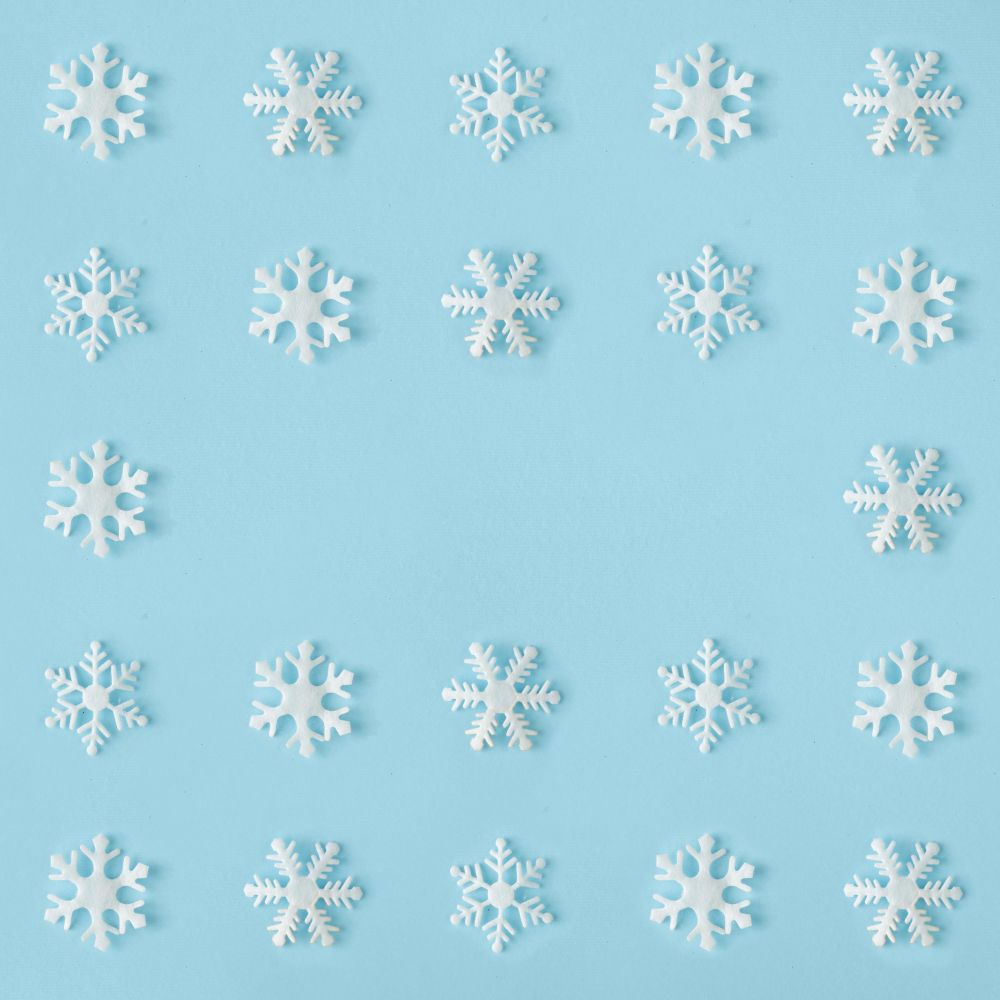 Snowflakes arranged on blue background