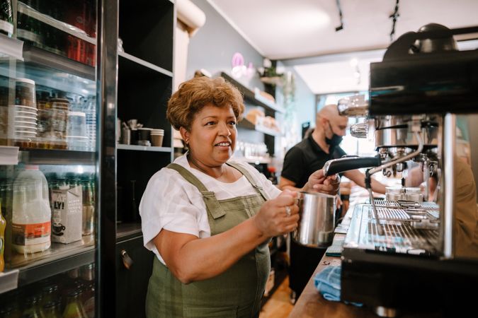 Older Black woman working as barista