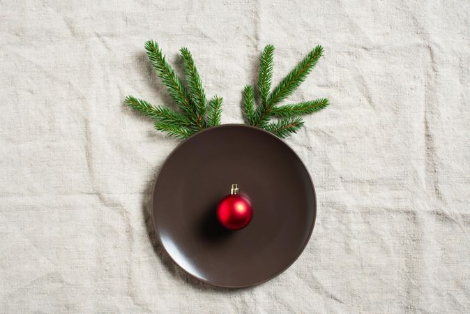 Fun table setting with pine cones and bauble making a reindeer