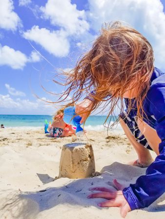 Young girl making sand castle