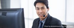 Banner of smiling man at work wearing headset 43KDg4