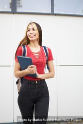 Portrait of smiling female student with backpack and notebook 5lQN74