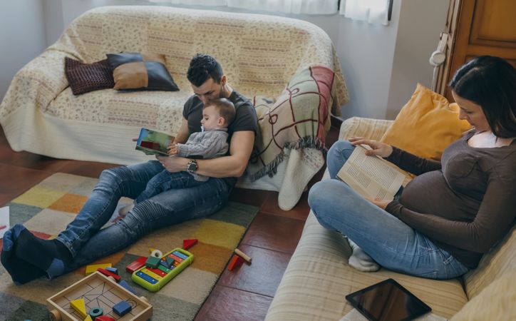 Family reading books in the living room