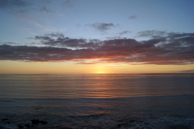 sandy and rocky beach and the ocean in sunset lights in canary island