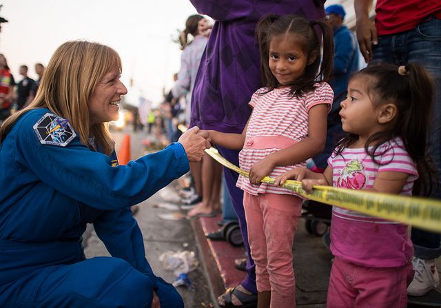 Astronaut Kay Hire greeting two young girls