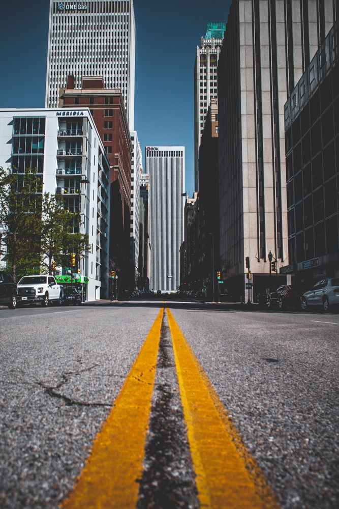 Road between building from low angle during daytime