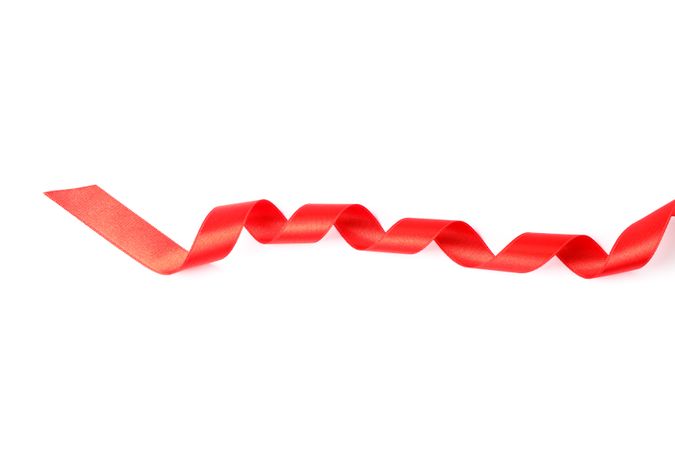 Red ribbon isolated on plain background. Gift concept