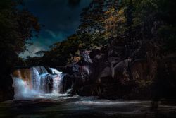 Rocky waterfall under evening sky
