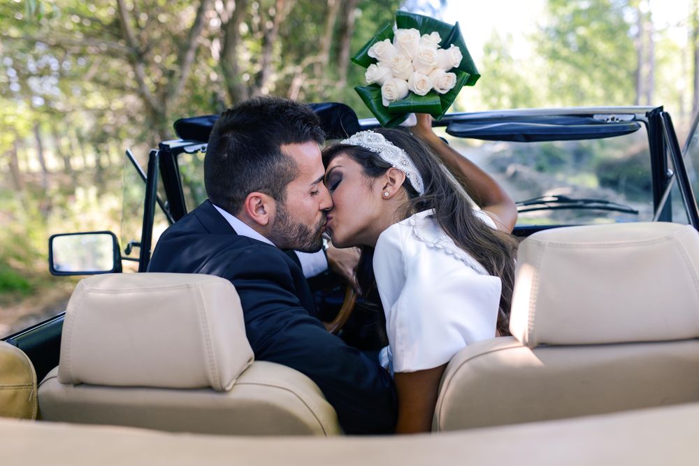 Newlyweds together after ceremony in vintage car