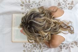 woman with book on the floor