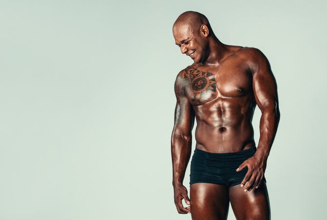 Fit tattooed Black man with muscular build