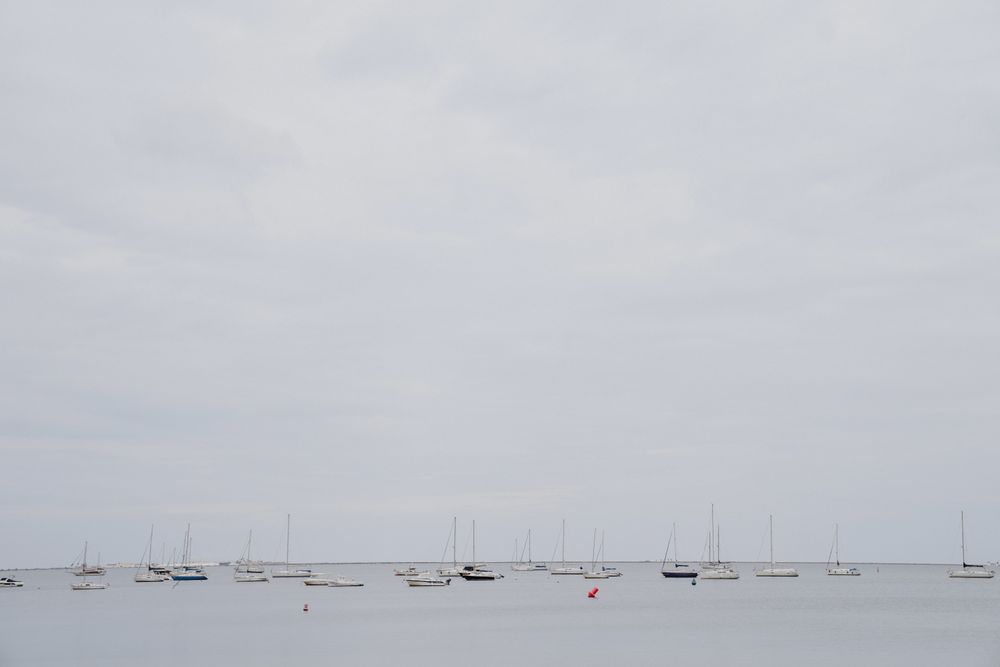 Yachts against overcast sky