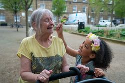 Older woman and grandchild walking outside