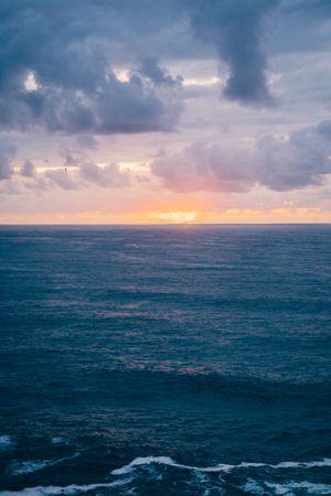 Grassy shore near stormy sea in evening