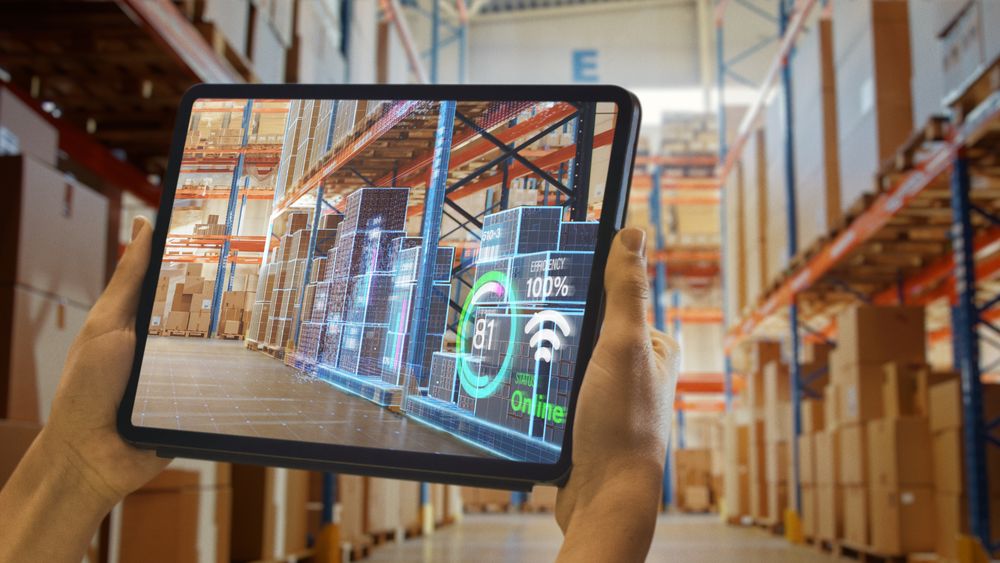 Futuristic Technology Warehouse: Worker Doing Inventory And Using Augmented Reality Application On Tablet.