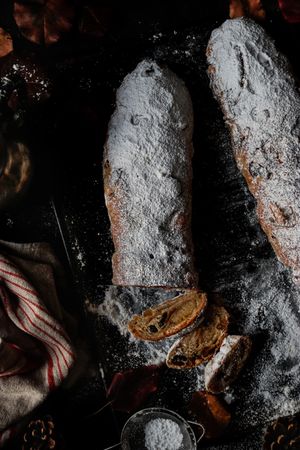 Pieces of Stollen near sieve and autumn leaves