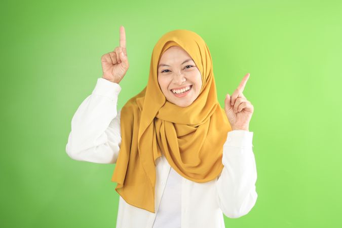 Asian Young Muslim  in Veil Woman Pointing on Copy Space