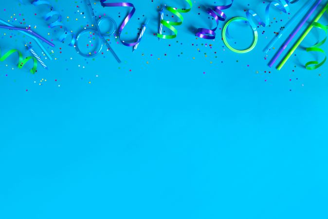 Party streamers on bright blue background