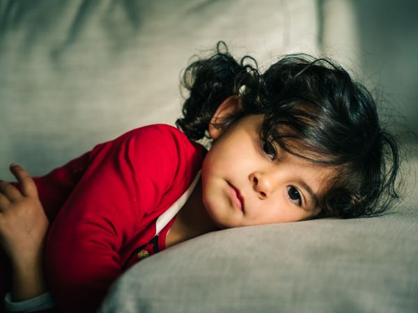 Cute dreamy girl lying down on pillow
