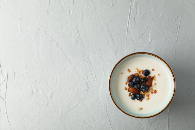Bowl with parfaits dessert on cement background