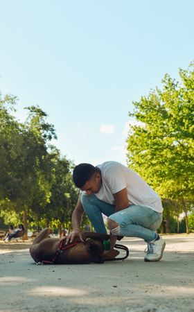 Man running and playing with his dog.