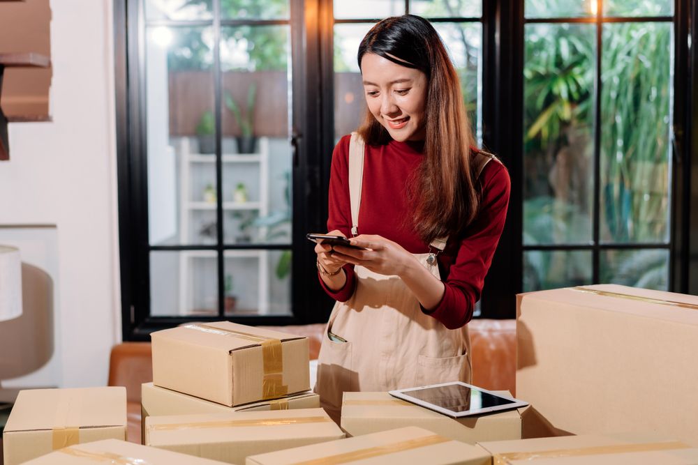 Asian woman and small business owner using smartphone