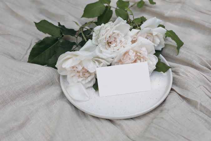 Festive floral composition with nude English roses with blank business card