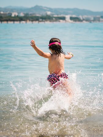 Cheerful girl having fun in warm sea