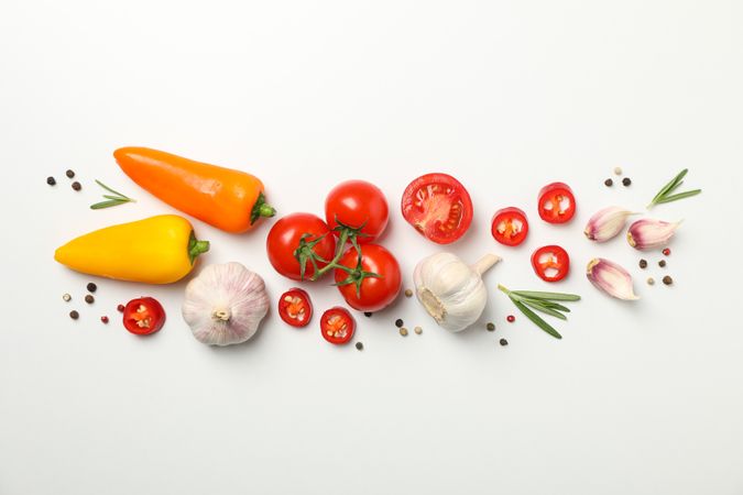Tomatoes and ingredients on neutral background, top view
