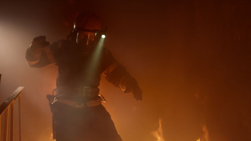 Firefighter runs down burning stairs