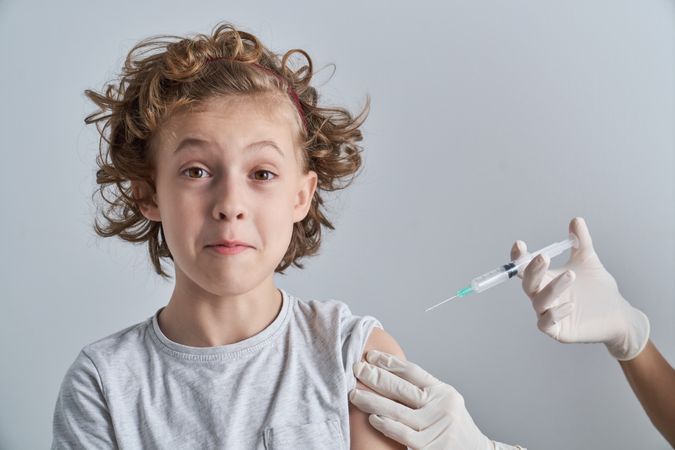 Curly child waiting for vaccine