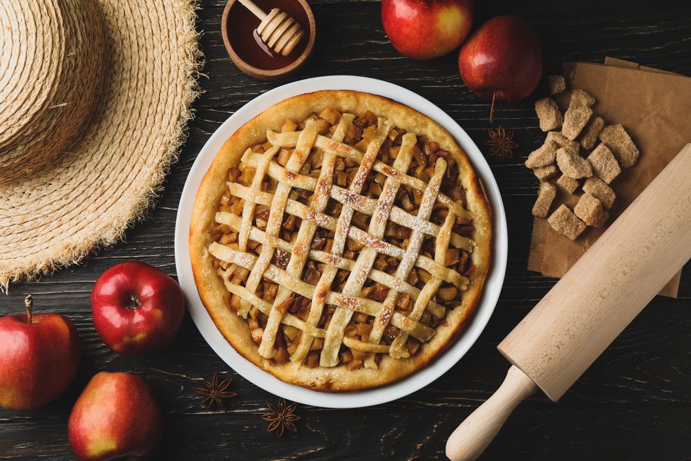 Composition with apple pie and ingredients on wooden background. Homemade food