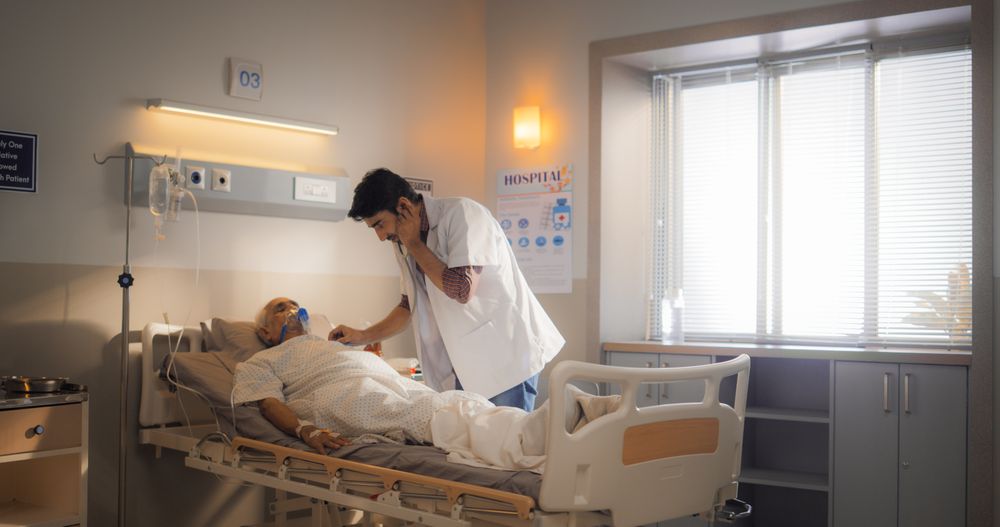 Portrait of a Young Intern Doctor Checking on his Patient in a Bright Modern Hospital.